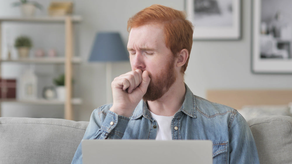 A man having a soar throat and coughing